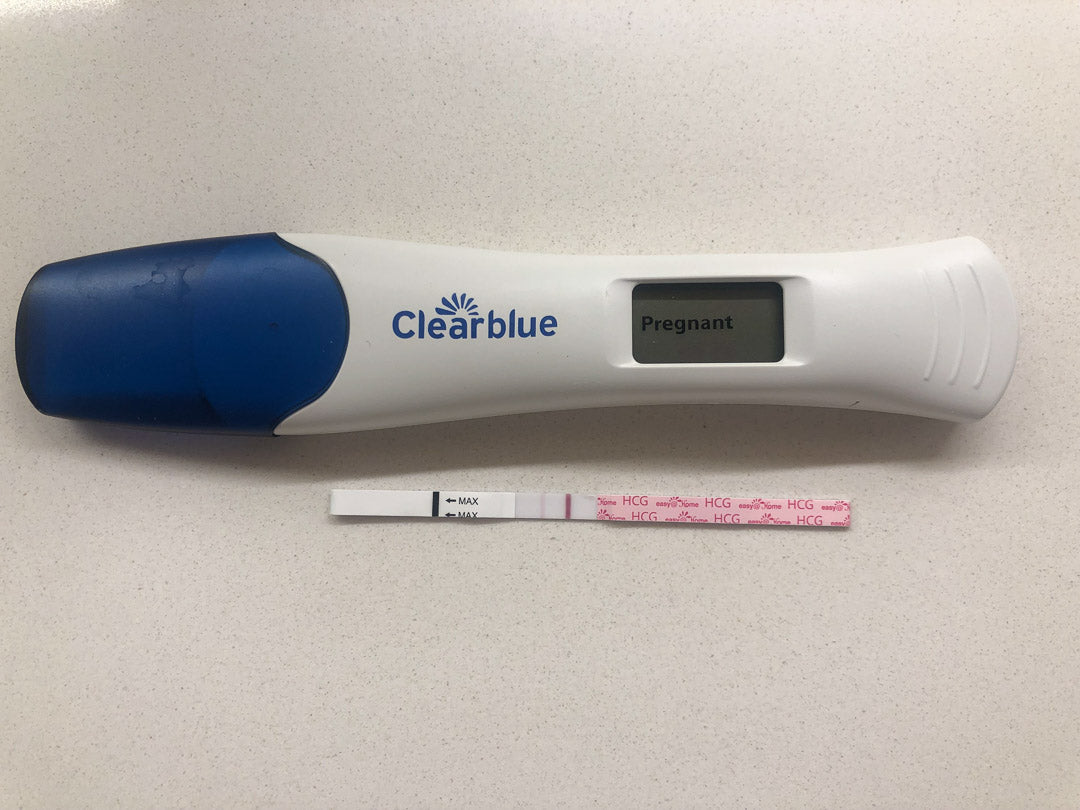 Two positive pregnancy tests on white counter