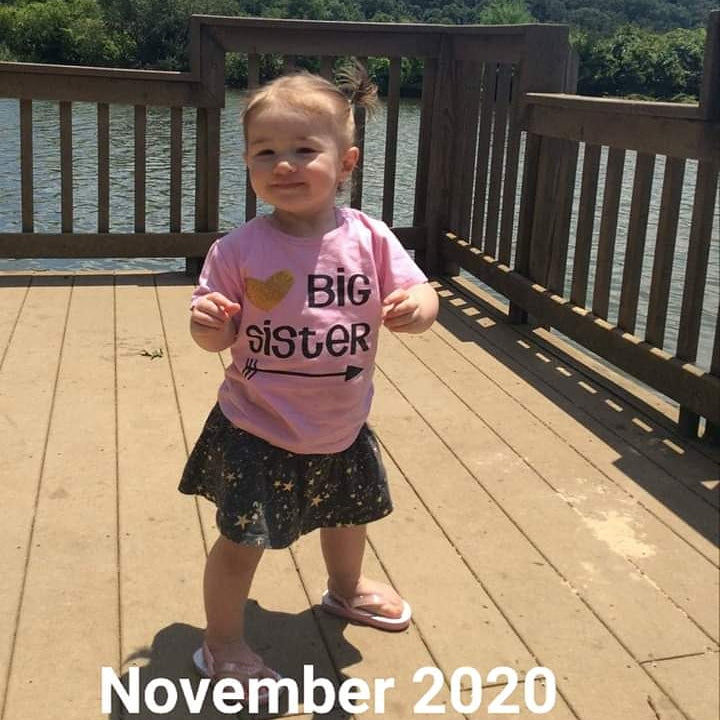 Toddler created with Mosie Baby wears shirt that reads "Big Sister" celebrating another Mosie Baby in the family