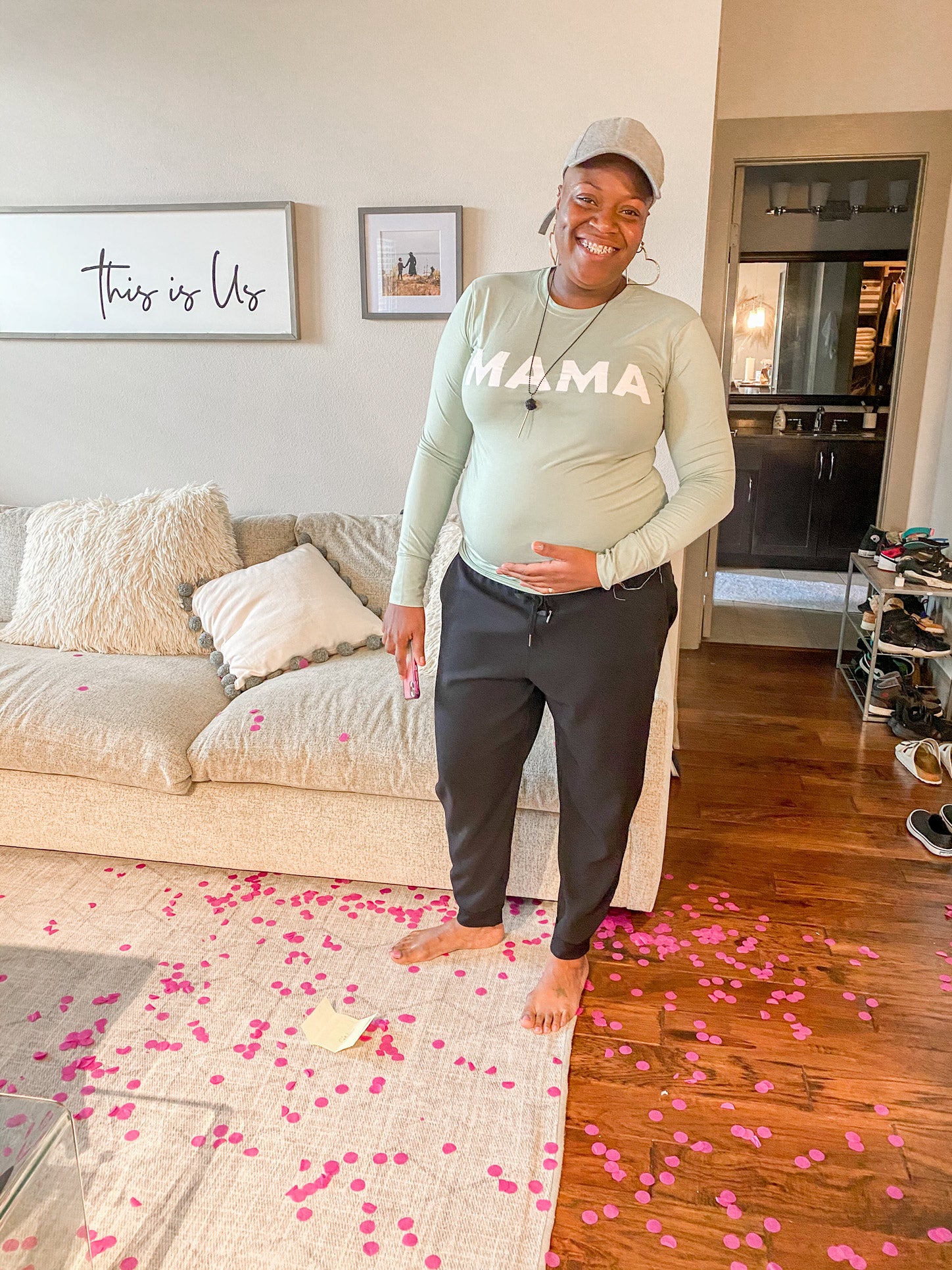 Single LGBTQ Mama-to-be stands holding her belly celebration of her Mosie baby announcement!