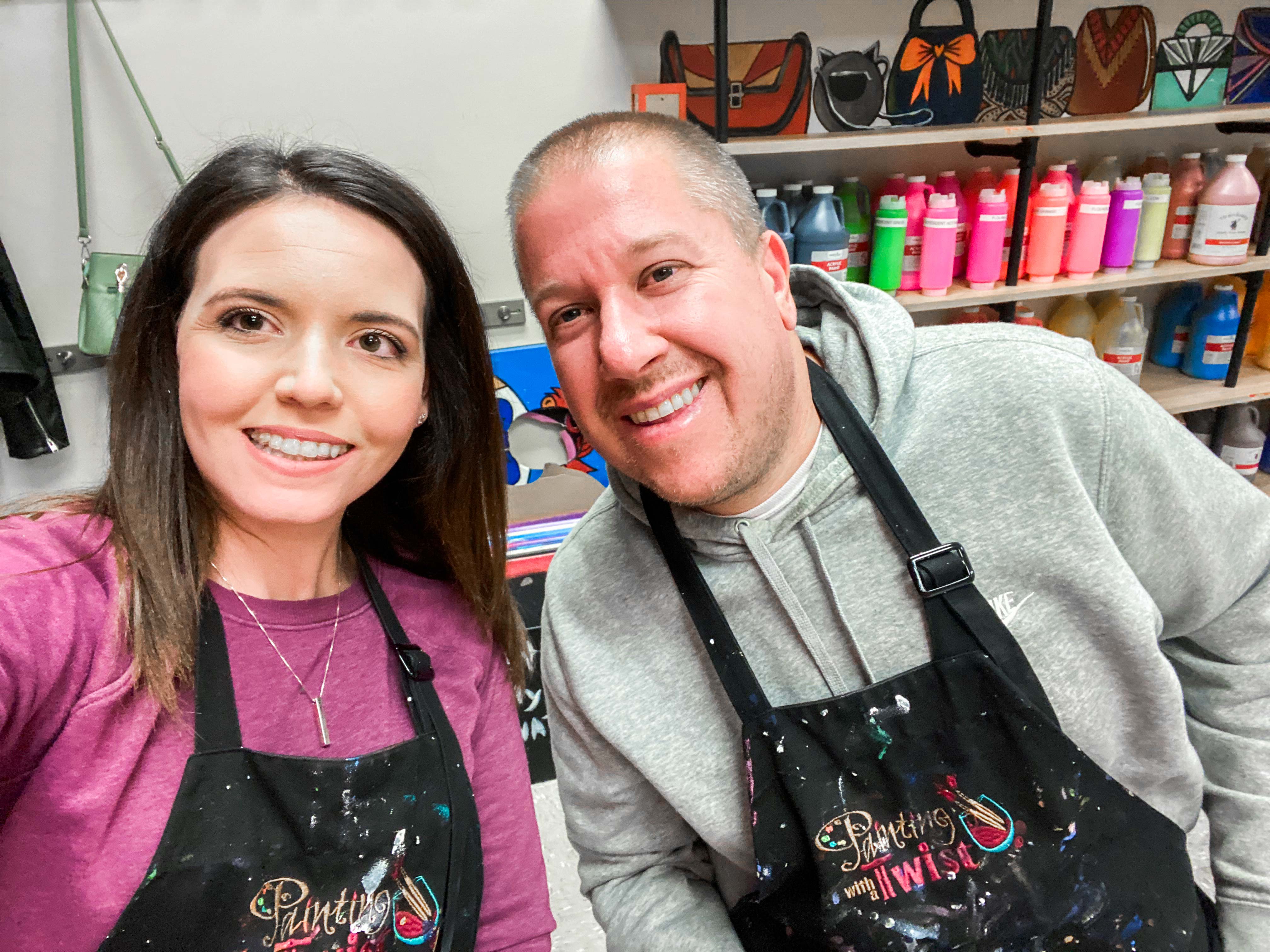 Husband and Wife take selfie at Painting with a Twist class.