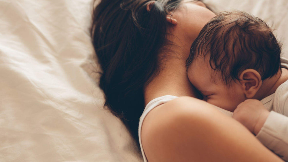 Mom and newborn baby on a bed