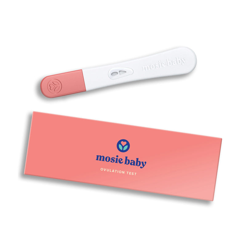 A Mosie Baby Ovulation Test and pink rectangular box on a beige background